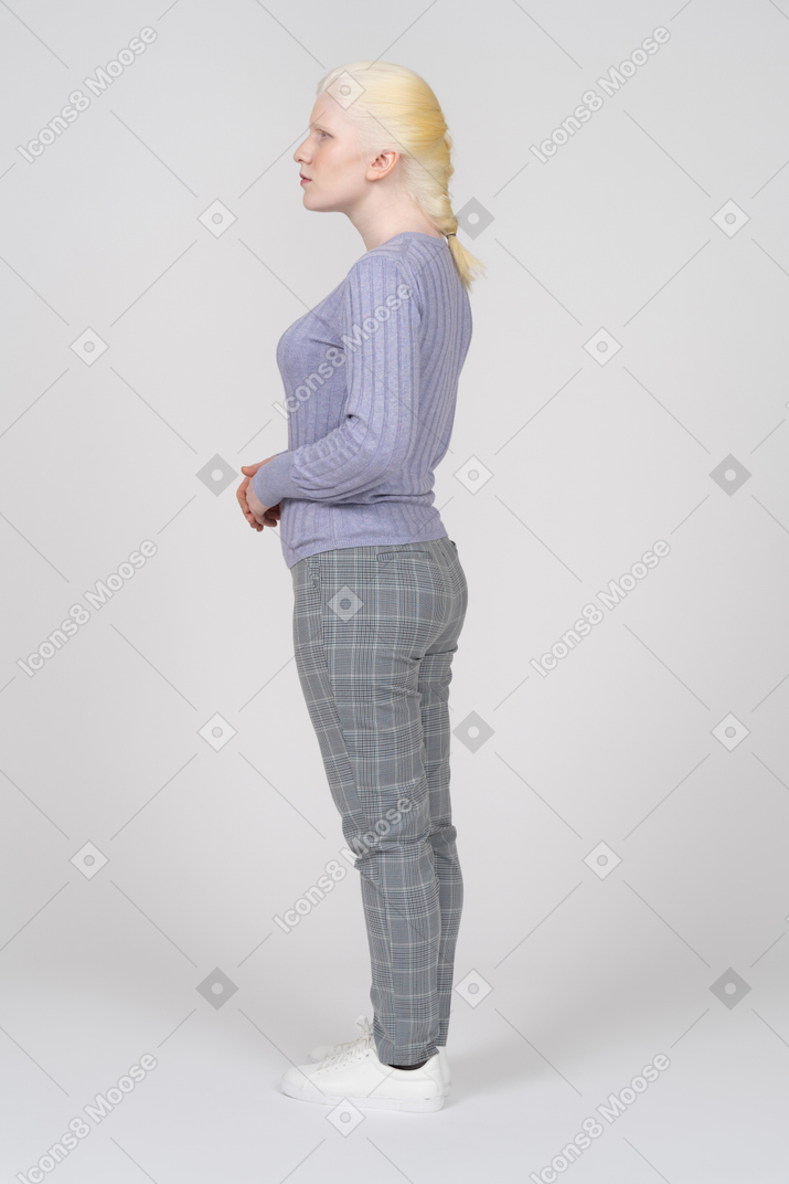 Side view of a young woman in casual clothes looking away