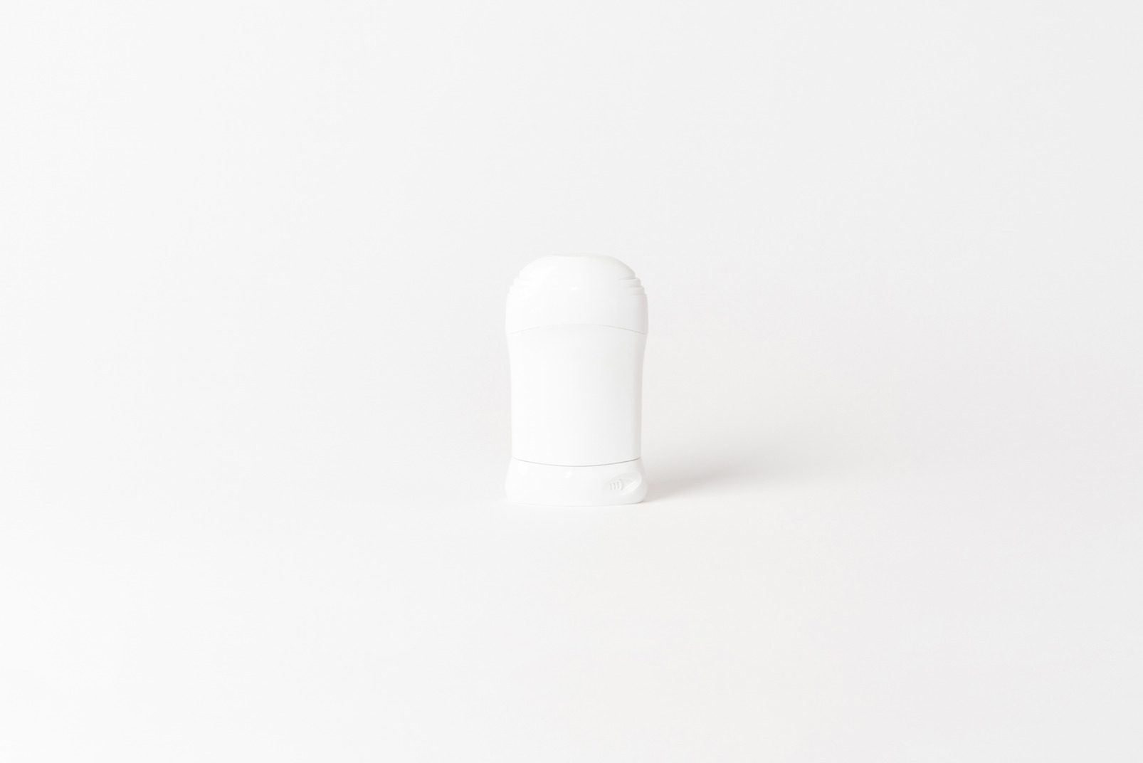 White plastic deodorant bottle on white background