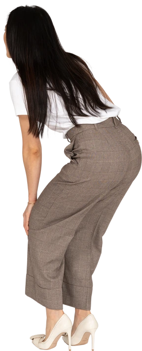 Three-quarter back view of a young lady in breeches and t-shirt leaning forward