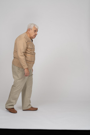 Side view of an old man walking