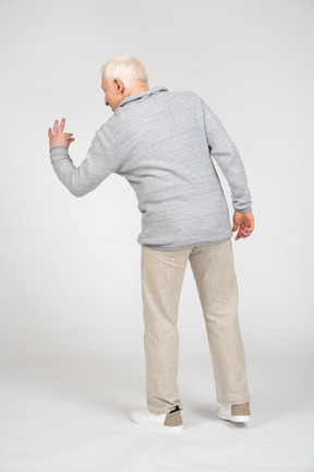 Back view of a man showing small size with his fingers