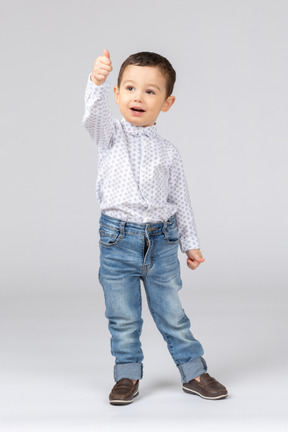 A little boy showing thumbs up