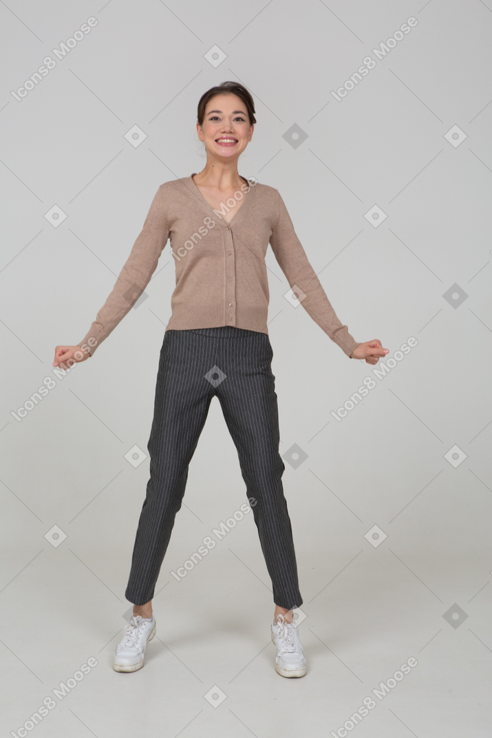Front view of a delighted lady in beige pullover outstretching her hands