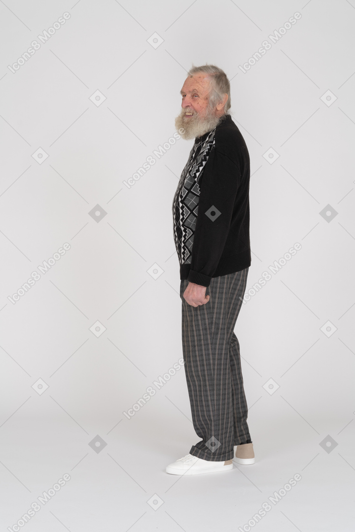 Side view of an old man standing and smiling