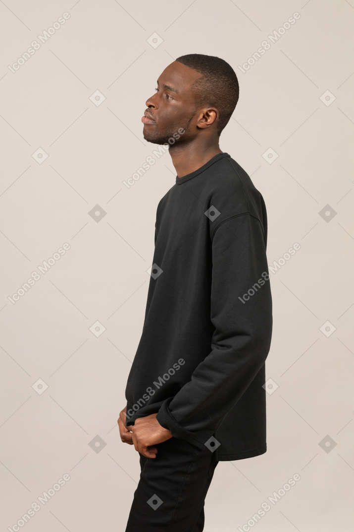 Side view of relaxed man with hands in pockets