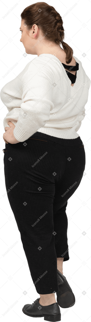 Plus size woman in white sweater posing