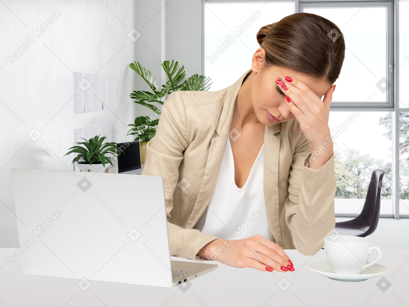 Portrait of a young business woman sitting at her desk and working on a laptop