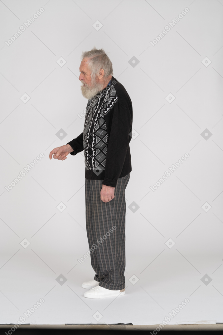 Side view of old man scolding with finger