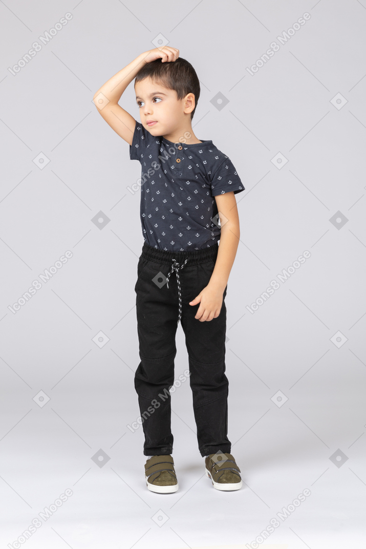 Vista frontal de un chico lindo en ropa casual rascándose la cabeza