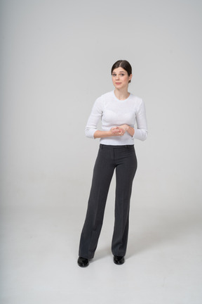 Front view of a woman in black pants and white shirt