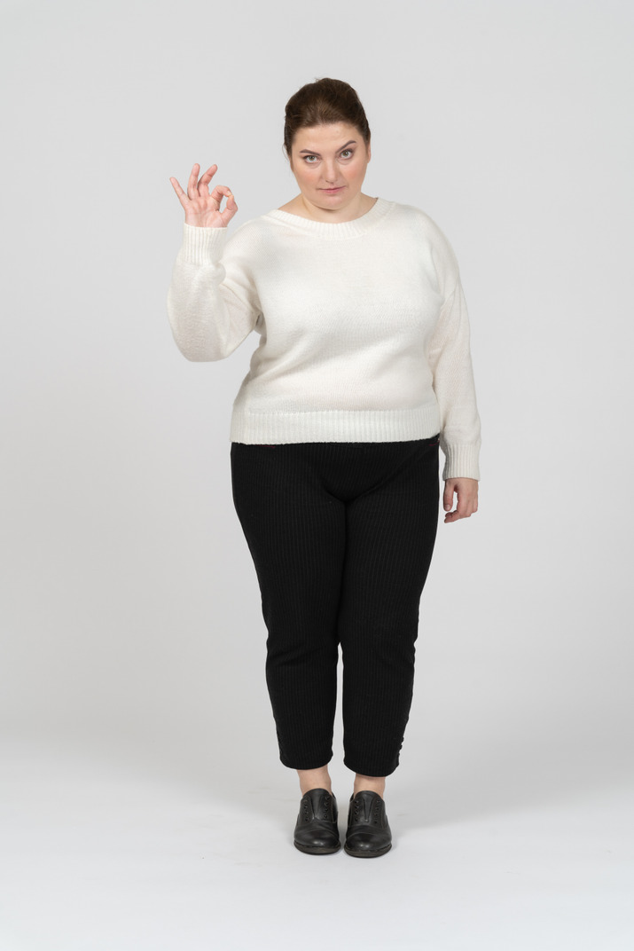 Plus size woman in casual clothes showing ok sign