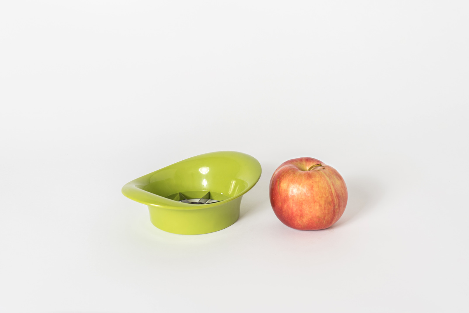 Apple and apple cutter on white background