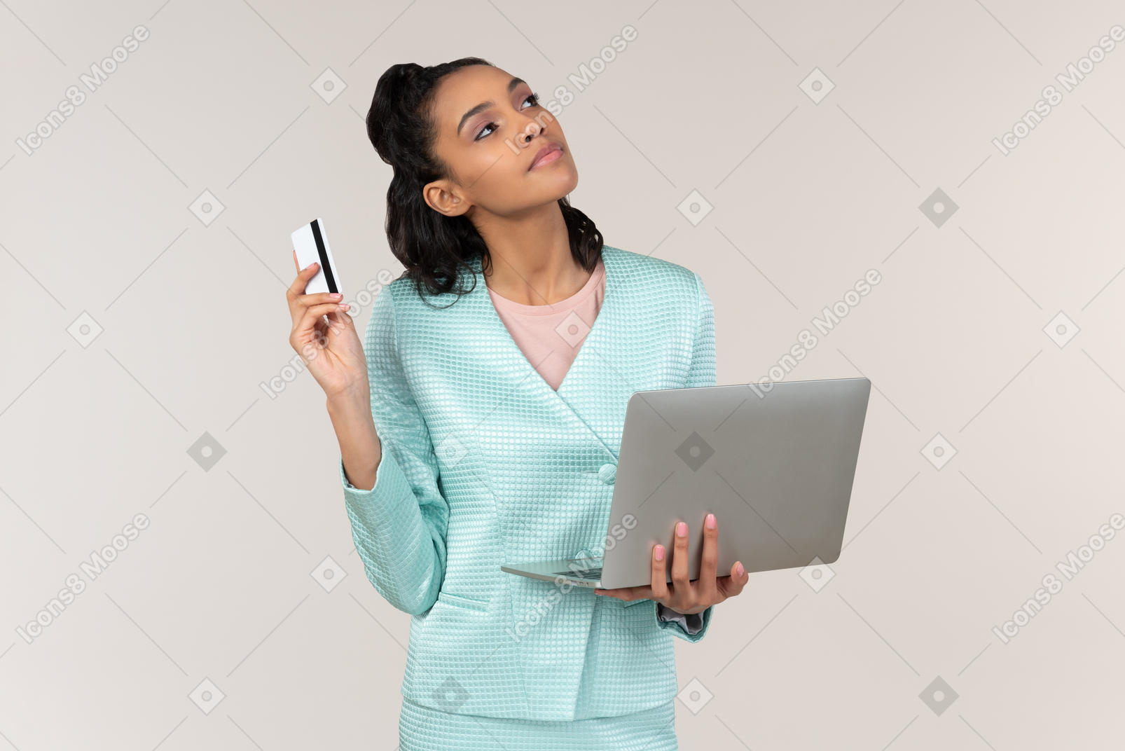 Pensive young afrowoman holding laptop and bank card