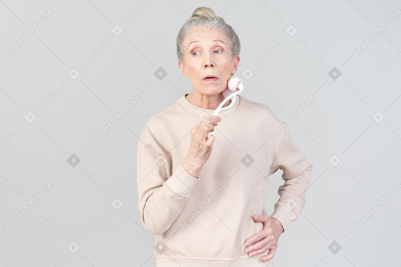 Old lady with face massage roller