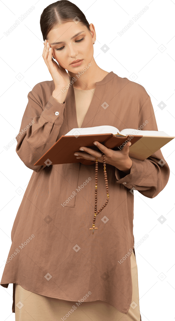 Young woman touches her temple while reading