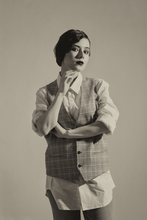 Beautiful retro-styled woman posing in checkered vest