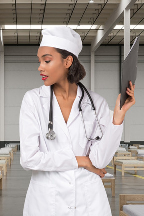 A woman in a white lab coat holding a clipboard