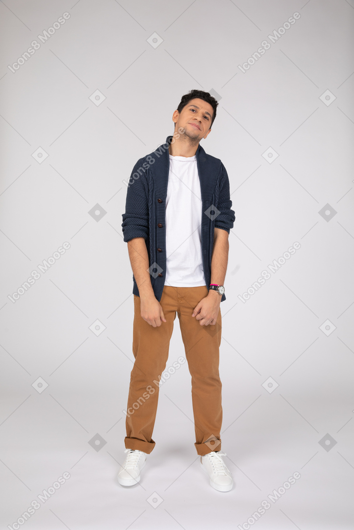 Smiling young man in pants and cardigan