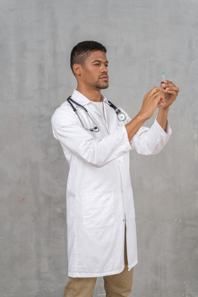 Male doctor preparing a syringe