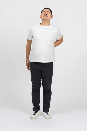 Front view of a man suffering from back pain