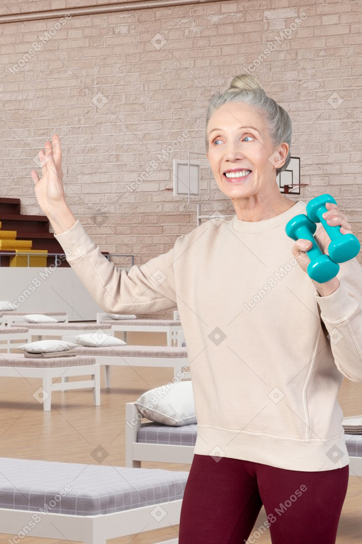 A woman holding a bowling ball in her hand