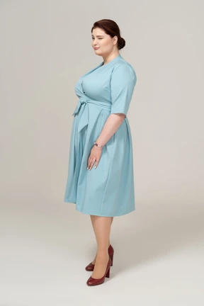 Side view of a woman in blue dress
