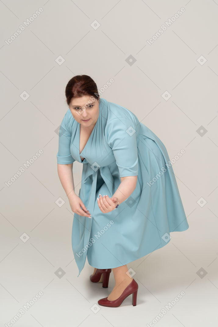 쪼그리고 앉는 파란 드레스에 여자의 전면보기