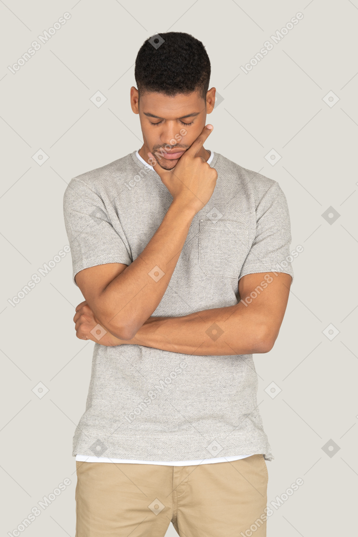 Good looking guy standing with closed eyes and thinking