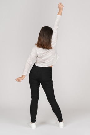 Back view of an awaken young indian female in casual clothes stretching her arms