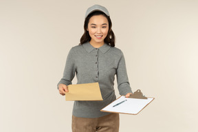 Young asian delivery girl carrying box and folder