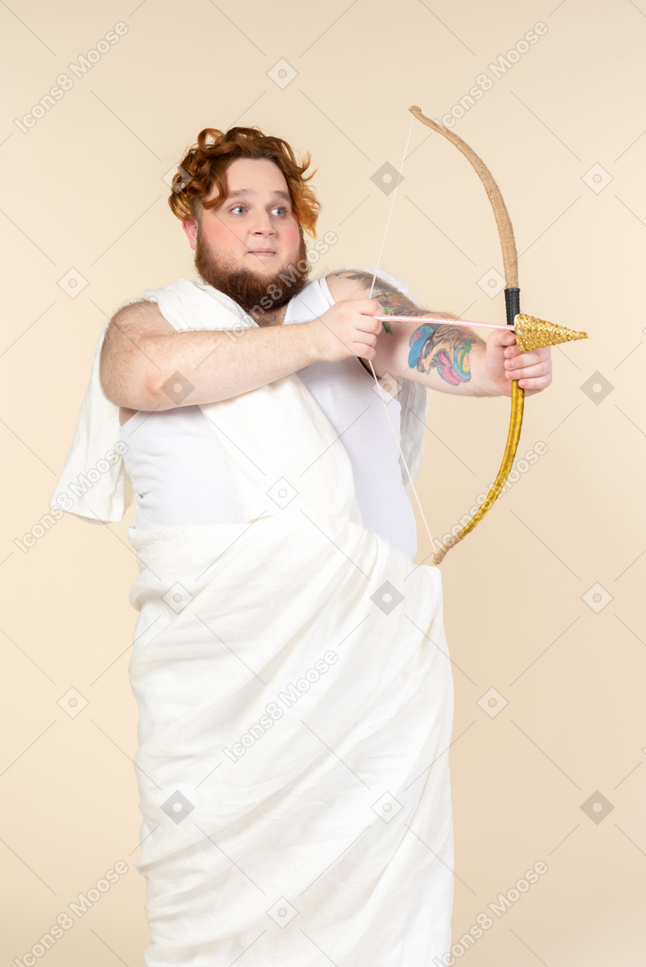 Scared looking young big man pointing with an arrow