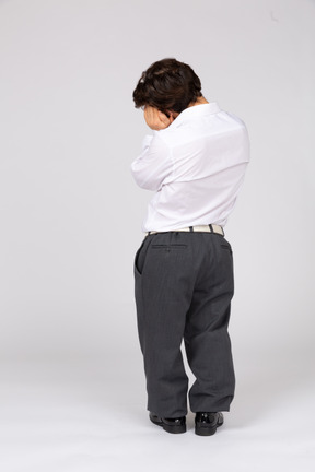 Back view of an office worker with hands under cheek