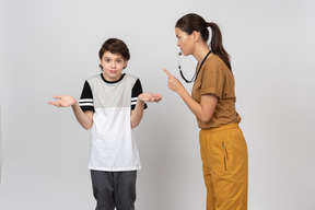 Physical education female teacher explaining something to the pupil