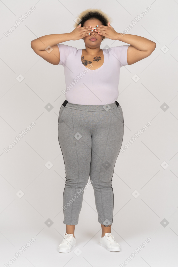 Body positive afro woman covering eyes with both palms