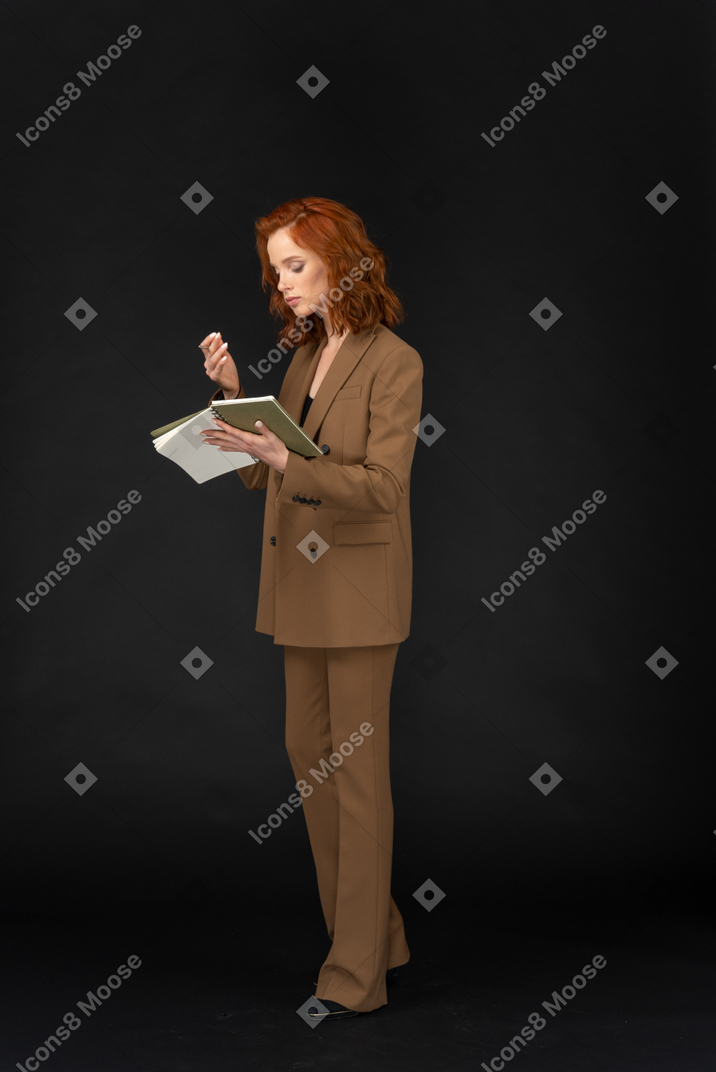 Young formally dressed woman reading a book