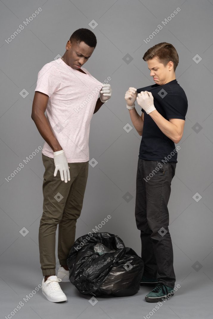 Two friends checking their t-shirts for a dirt
