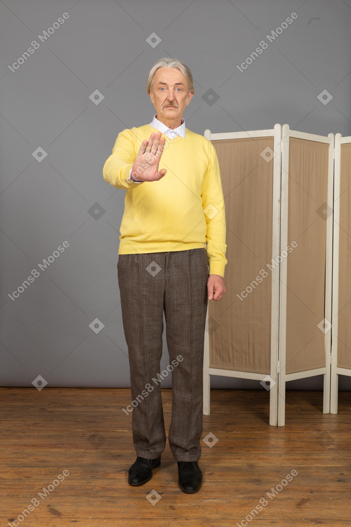 Front view of an old man raising hand