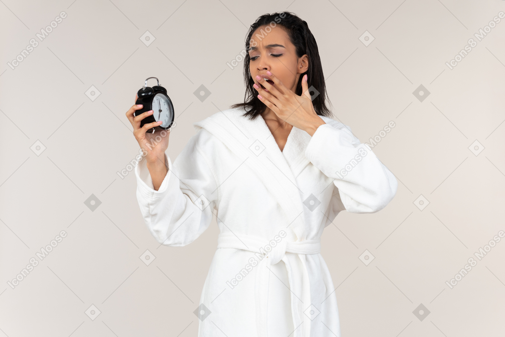 Black woman in white bathrobe going about her morning routine