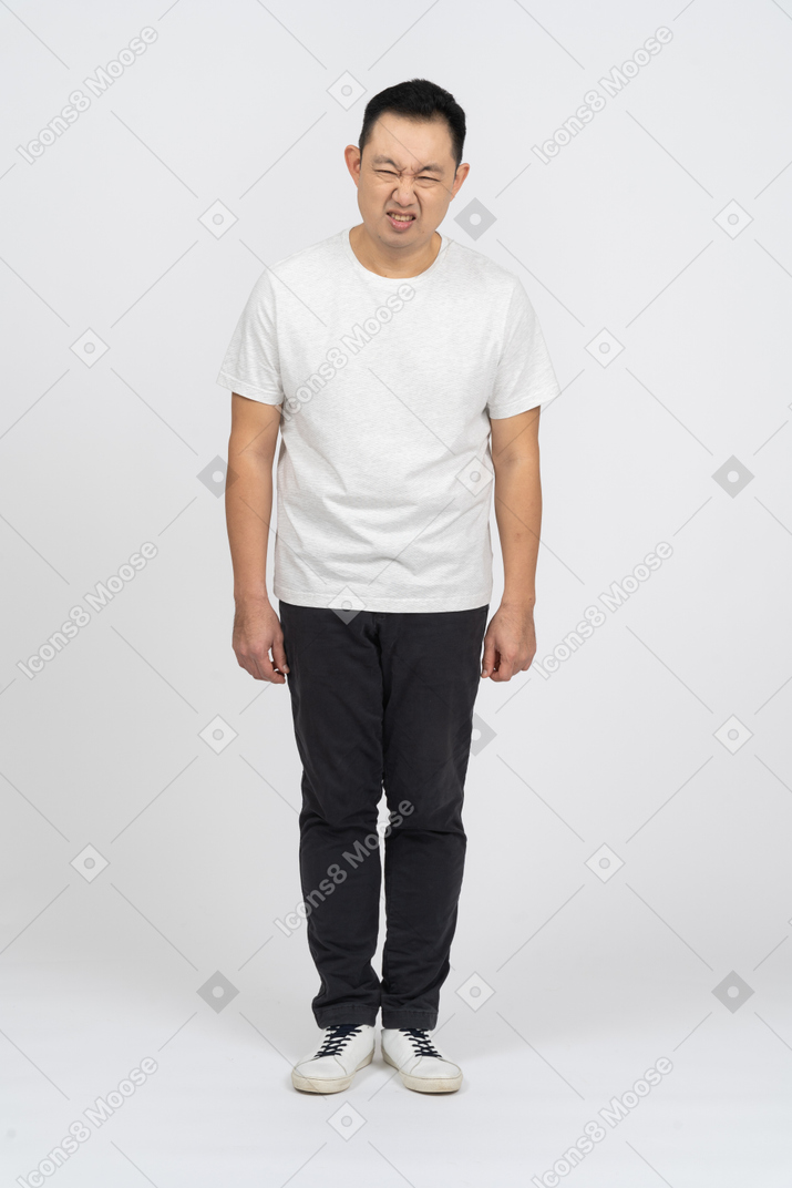Front view of a man in casual clothes making funny face