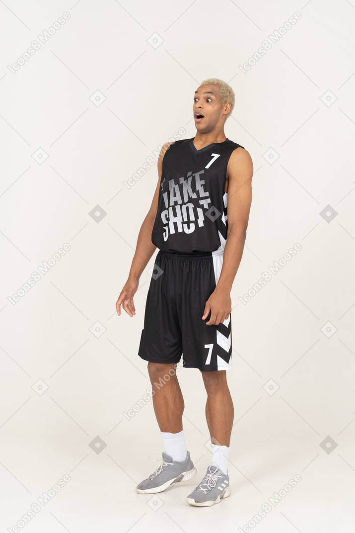 Three-quarter view of a shocked young male basketball player
