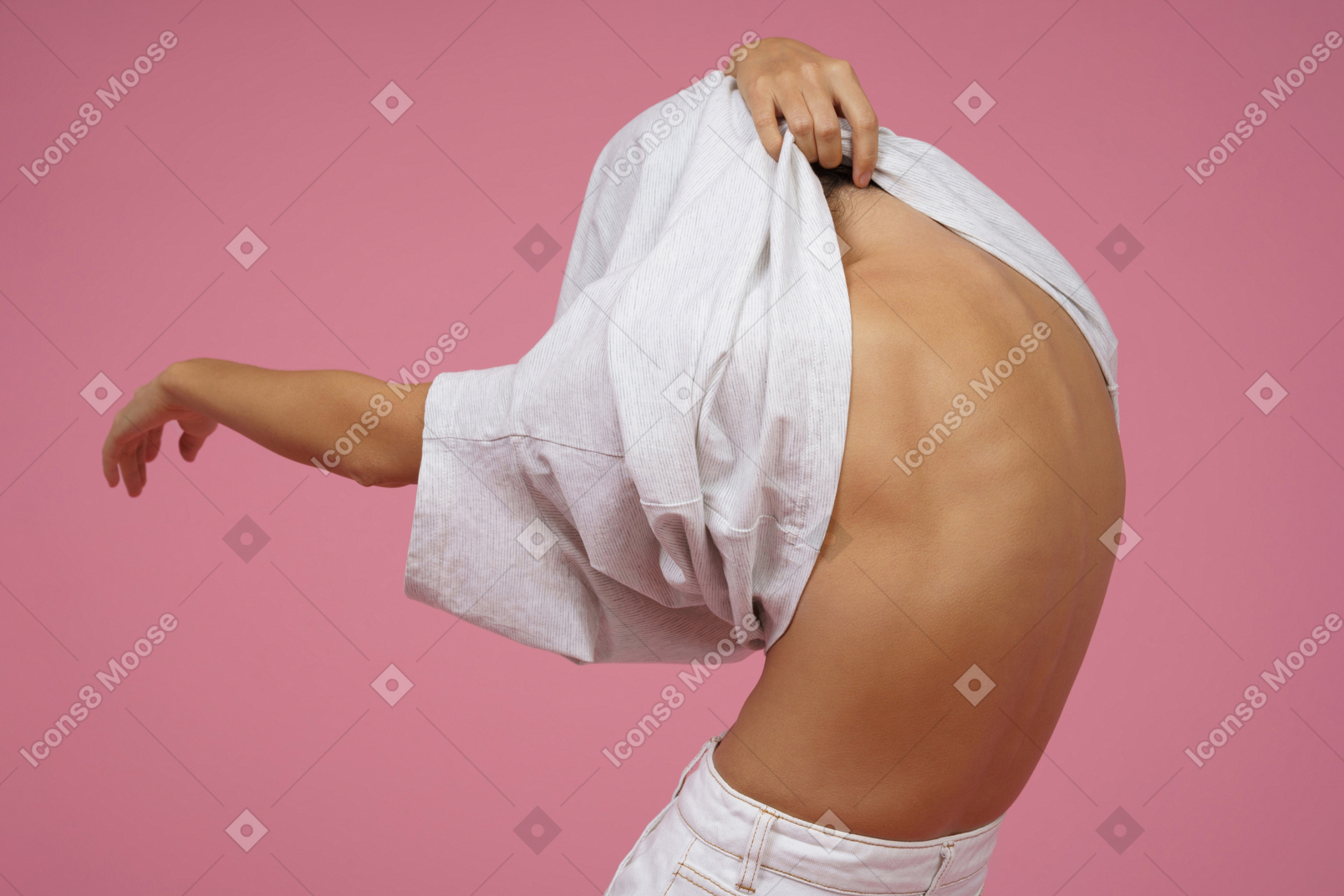 Young woman taking off her t-shirt