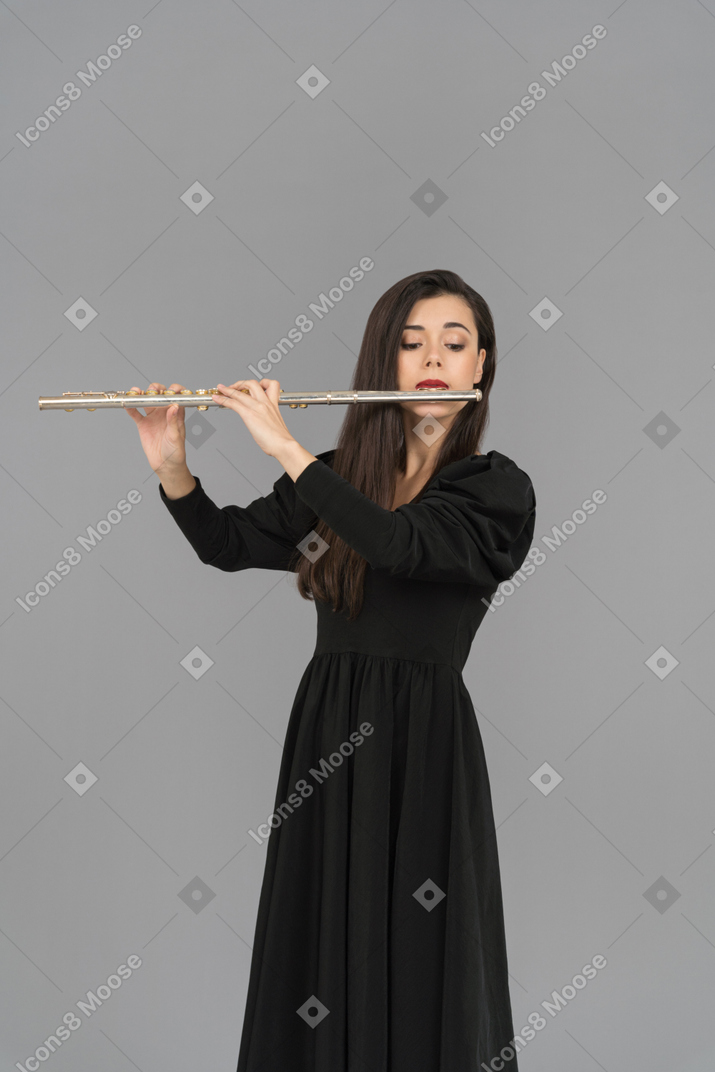 A female musician playing a flute
