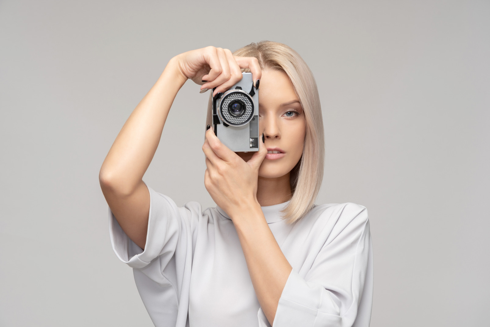Young attractive woman hoding a camera