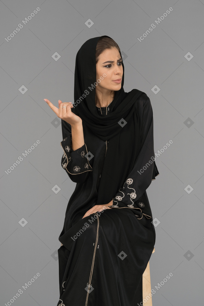 A young muslim woman being skeptical
