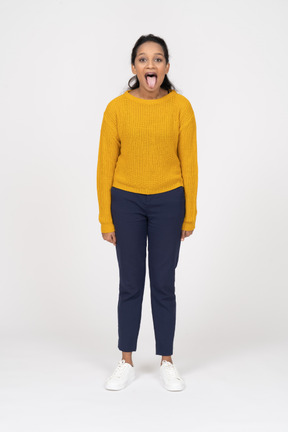 Vista frontal de uma garota com roupas casuais, mostrando a língua
