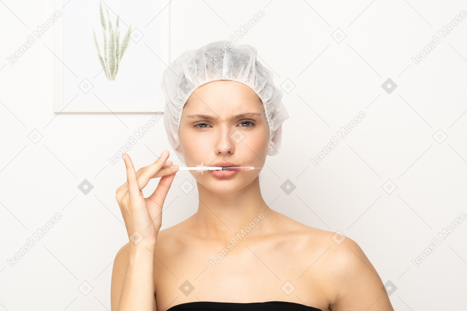 Young woman holding syringe in her mouth