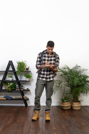 Front view of a tourist writing in his planner