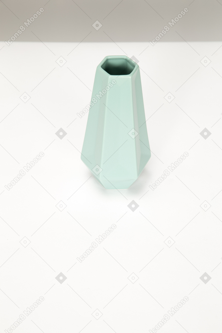 Empty grey vase on white table