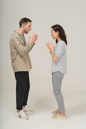 Side view of young couple speaking to each other