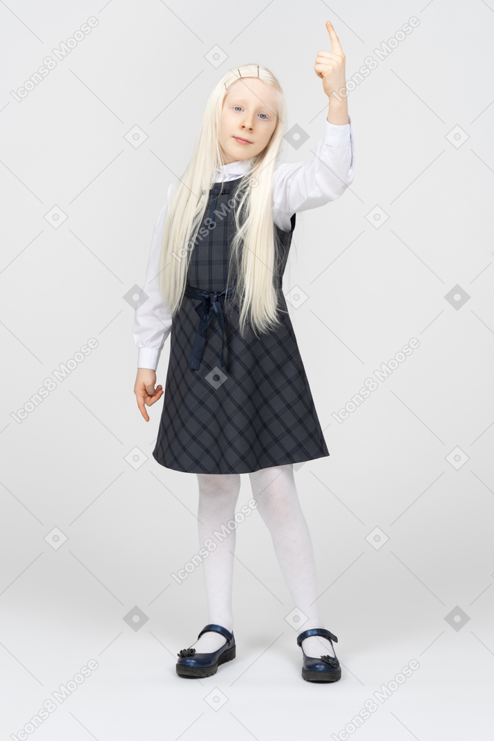 Schoolgirl pointing upwards